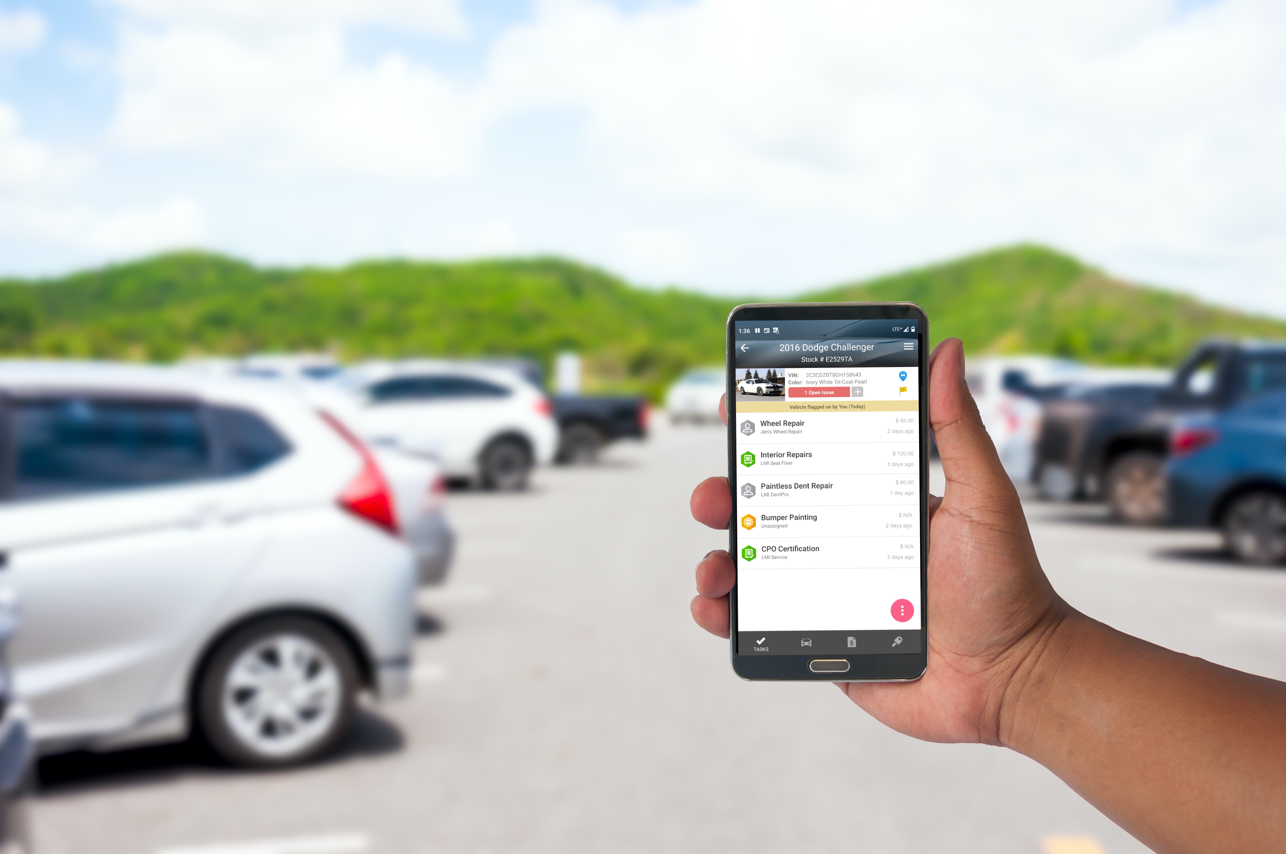 the hand of man hold mobile phone over blurred car parking with bokeh light Background; Shutterstock ID 450484543; PO: 506212963; Client: ff5f3263-2aae-448b-a934-c8a1c4b03232